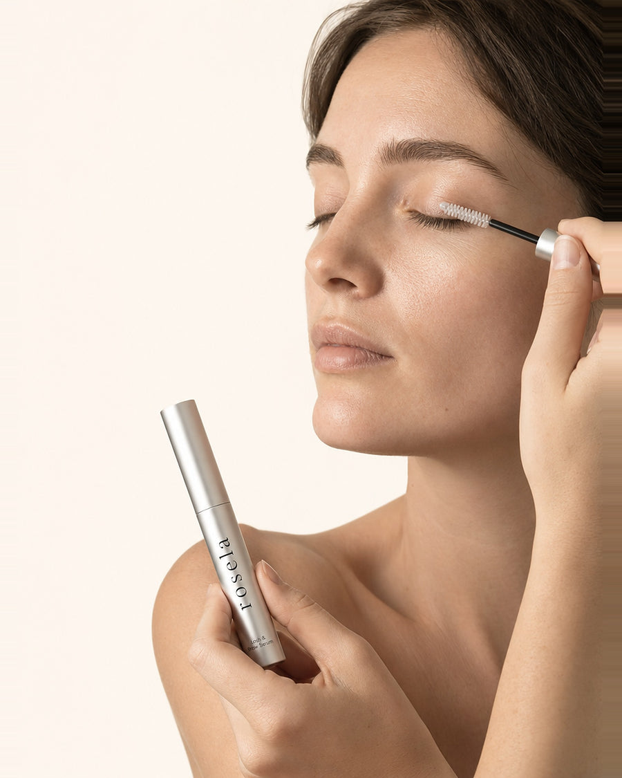 Applying Rosela Nightly along the upper lash line